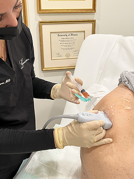 Dr. Karipidis injecting PRP into a shoulder