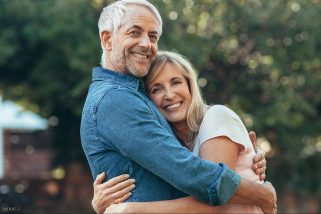 Mature couple hugging and smiling (models)