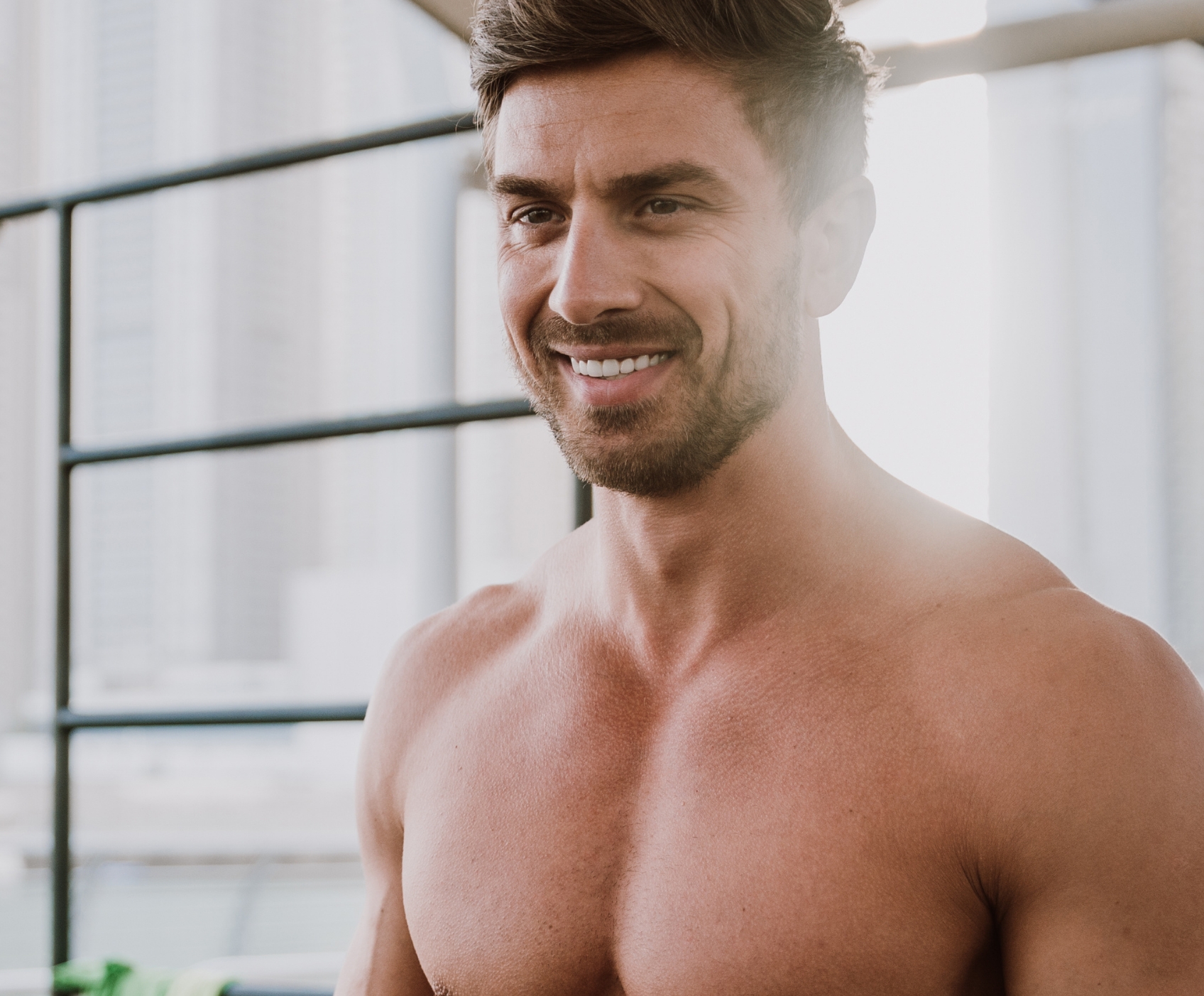 Man not wearing a shirt smiling