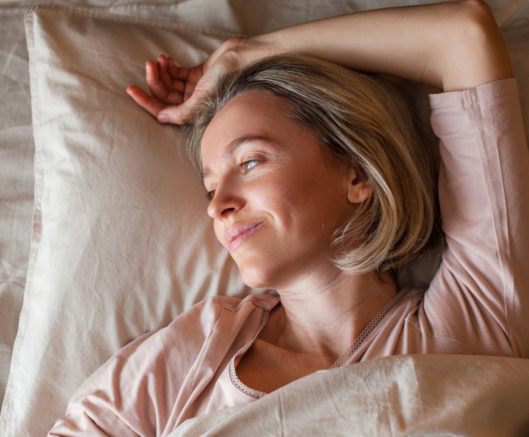 Woman laying on bed staring